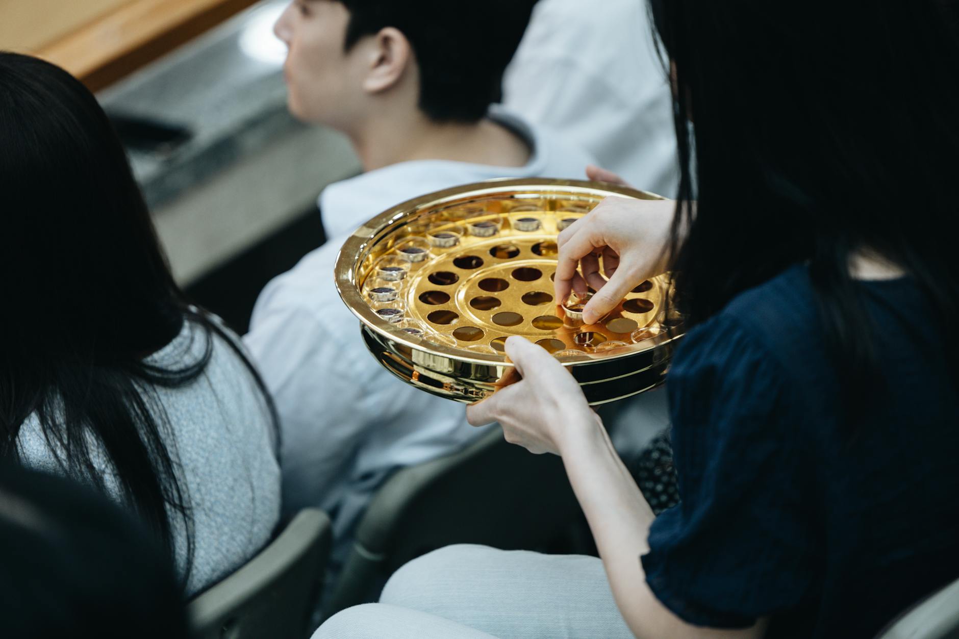 Hands giving an offering representing Christian tithing and generosity